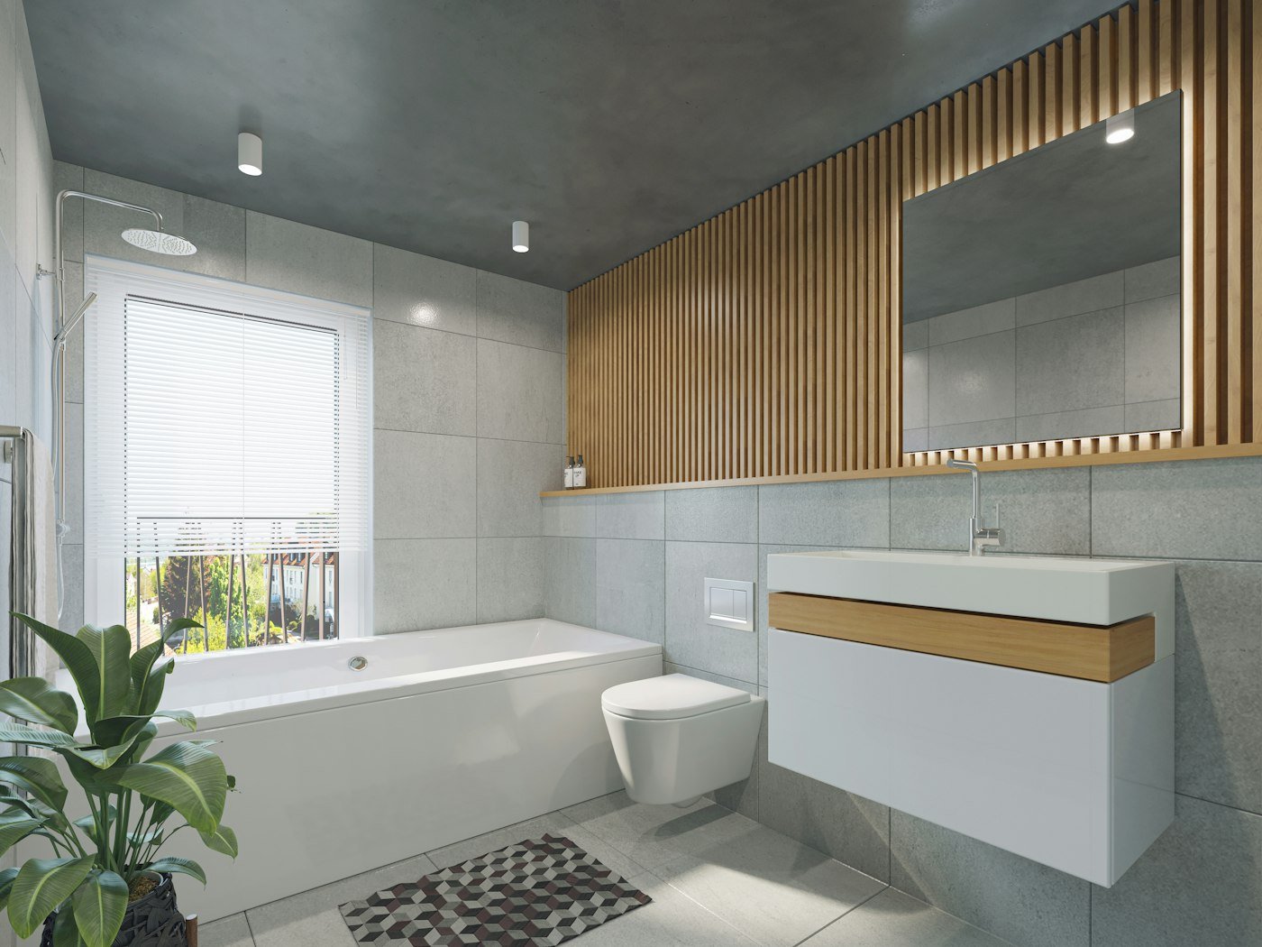 A grey tiled bathroom with a white bath, a wood slat wall, and a window with blinds